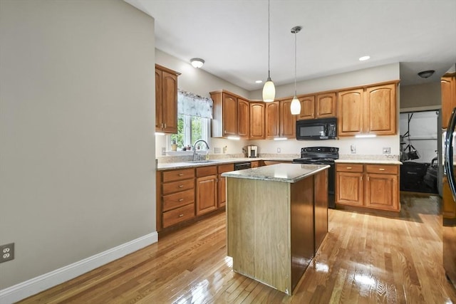 17 Sean Mikeal Way, Grafton, MA 01519 - kitchen featuring black appliances, light wood finished floors, a kitchen island, baseboards, and pendant lighting