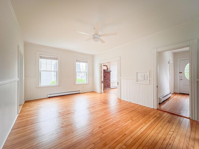 19 Center St, Weymouth, MA 02189 - spare room with a baseboard heating unit, light wood-style flooring, wainscoting, and ceiling fan