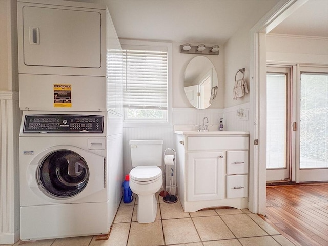 19 Center St, Weymouth, MA 02189 - bathroom featuring stacked washer / drying machine, wainscoting, vanity, and tile patterned flooring