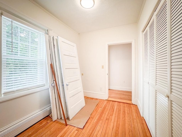 19 Center St, Weymouth, MA 02189 - hallway featuring a baseboard radiator, light wood-style floors, and crown molding
