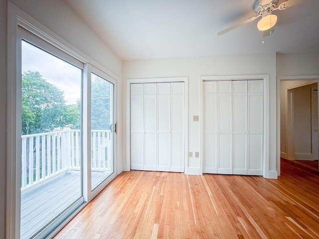 19 Center St, Weymouth, MA 02189 - unfurnished bedroom featuring access to exterior, light wood-type flooring, two closets, and ceiling fan