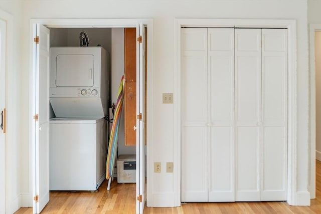 19 Center St, Weymouth, MA 02189 - laundry area with estacked washer and dryer and light wood-style flooring
