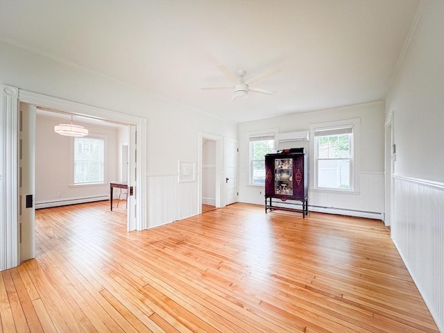 19 Center St, Weymouth, MA 02189 - unfurnished living room with light wood-type flooring, a baseboard radiator, wainscoting, and a ceiling fan