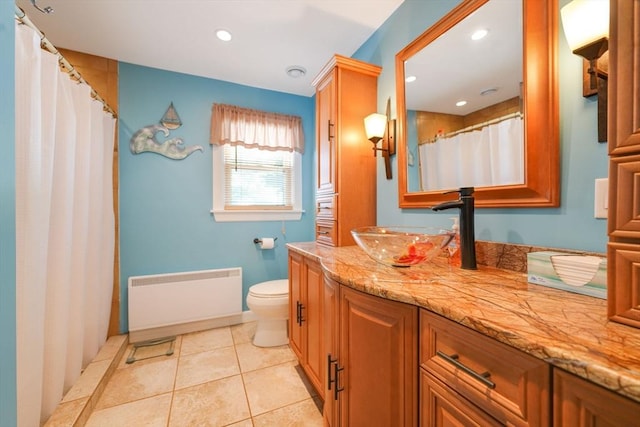 329 Brooklawn Ave, New Bedford, MA 02745 - bathroom with radiator, toilet, vanity, recessed lighting, and tile patterned floors
