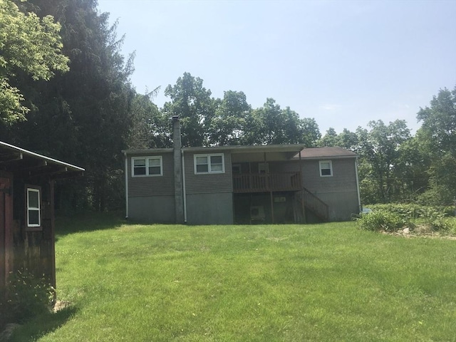 46 Mill Rd, Dudley, MA 01571 - rear view of house featuring stairs, a yard, and a wooden deck