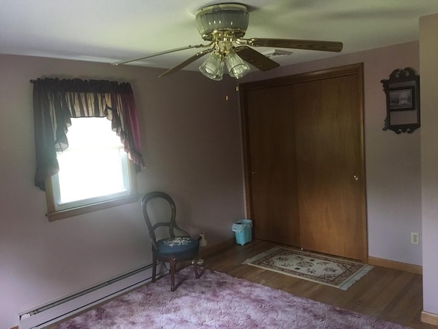 46 Mill Rd, Dudley, MA 01571 - unfurnished bedroom featuring wood finished floors, a ceiling fan, baseboards, and a baseboard radiator