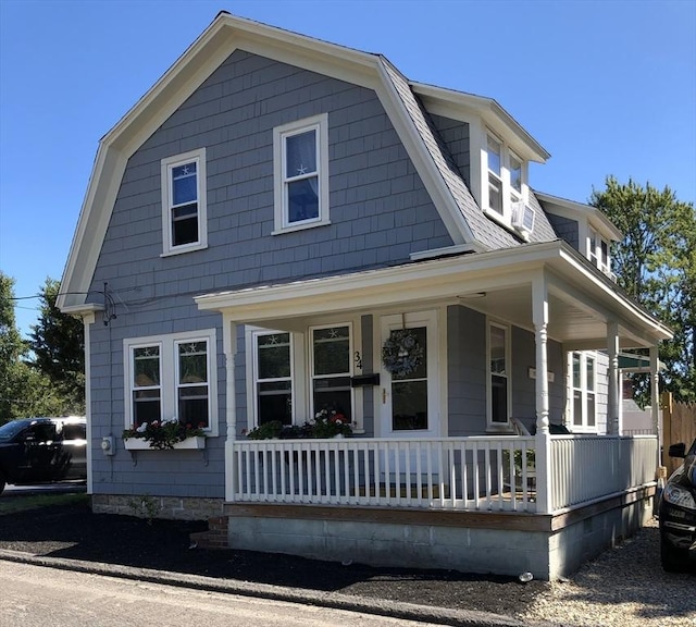 view of front of property with covered porch and a gambrel roof