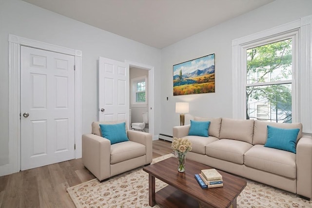 7 Cliff St, Attleboro, MA 02703 - living room with light wood finished floors, plenty of natural light, and baseboard heating