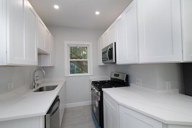 7 Cliff St, Attleboro, MA 02703 - kitchen featuring appliances with stainless steel finishes, white cabinetry, light stone counters, and recessed lighting