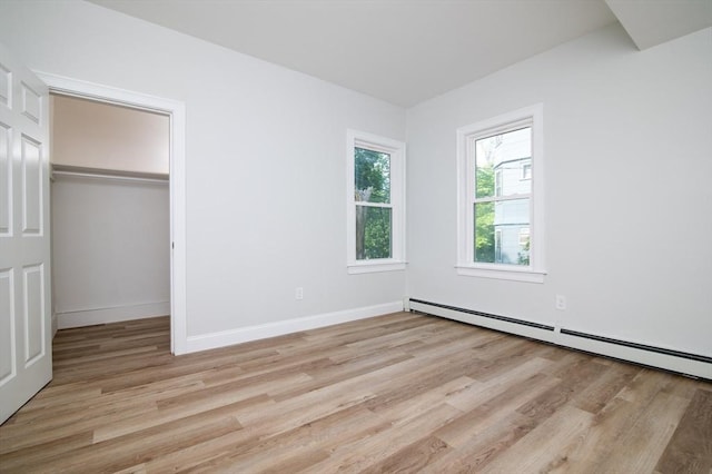 7 Cliff St, Attleboro, MA 02703 - unfurnished bedroom featuring light wood-style floors, a baseboard radiator, a closet, and a spacious closet