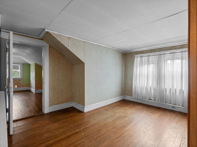bonus room featuring hardwood / wood-style floors and baseboards