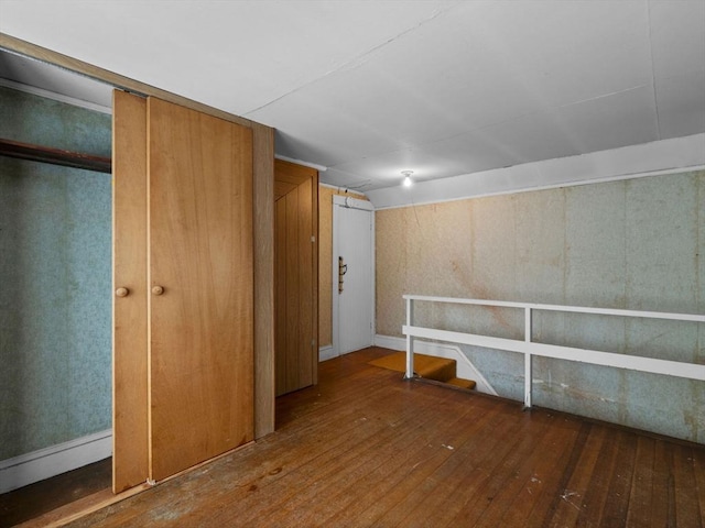 below grade area with hardwood / wood-style flooring