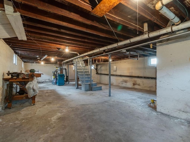 basement with stairway and secured water heater