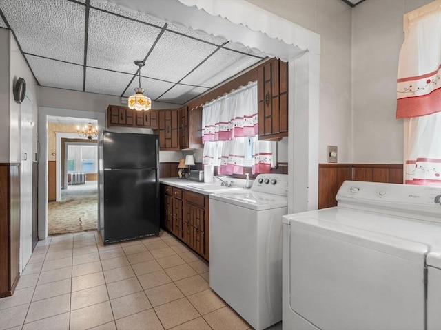 washroom featuring washer and dryer, wainscoting, a chandelier, and light tile patterned floors