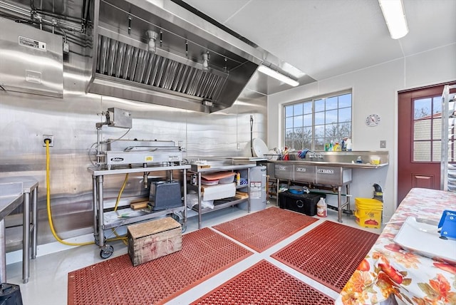 interior space with plenty of natural light, stainless steel counters, and concrete floors