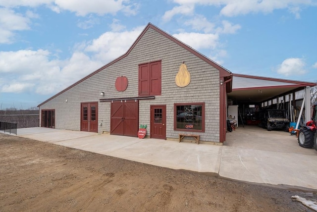 exterior space with an outbuilding and a carport