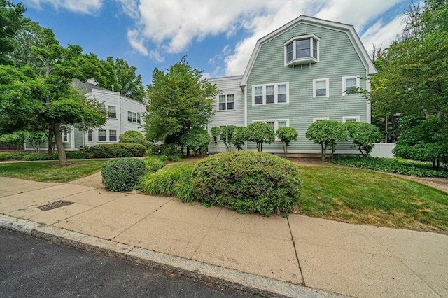 37 Hastings St Unit 207, Boston, MA 02132 - view of front facade with a front lawn and a gambrel roof