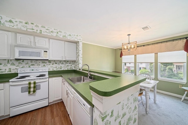 37 Hastings St Unit 207, Boston, MA 02132 - kitchen featuring white appliances, a peninsula, dark countertops, white cabinetry, and crown molding