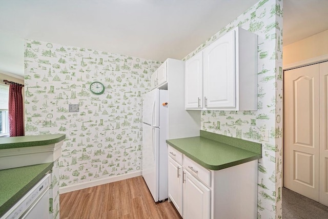 37 Hastings St Unit 207, Boston, MA 02132 - kitchen featuring wallpapered walls, white appliances, white cabinetry, light wood-style flooring, and dark countertops