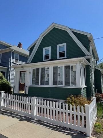 17 Olcott St, Watertown, MA 02472 - colonial inspired home featuring a fenced front yard and a gambrel roof