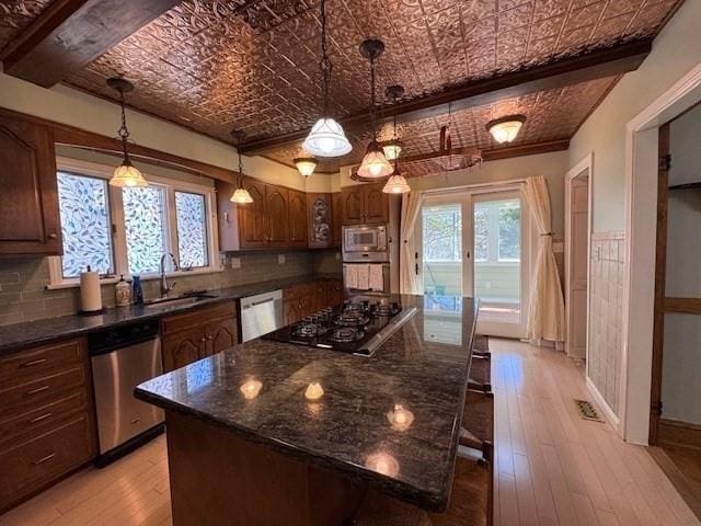 17 Olcott St, Watertown, MA 02472 - kitchen with gas stovetop, a sink, built in microwave, and dishwasher