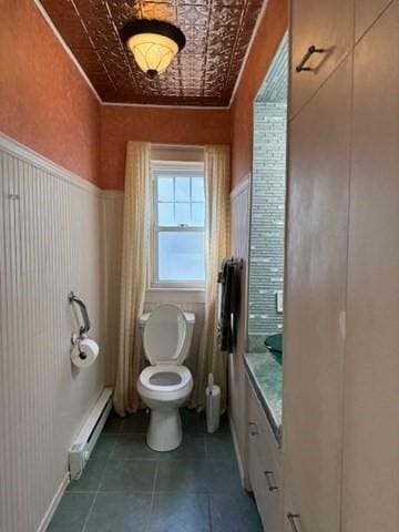 17 Olcott St, Watertown, MA 02472 - bathroom featuring an ornate ceiling, wainscoting, a baseboard heating unit, and toilet