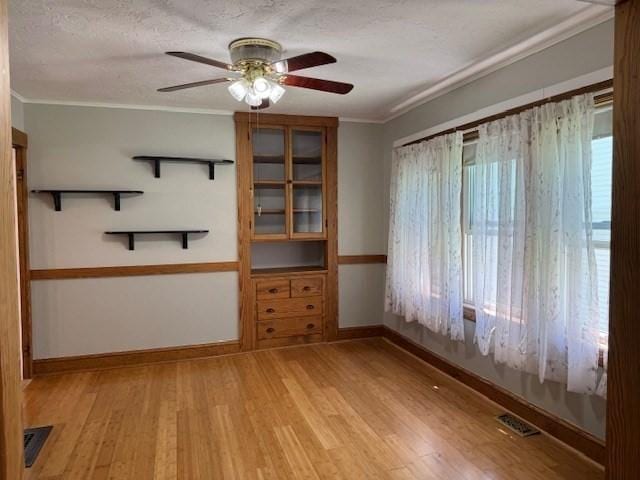 17 Olcott St, Watertown, MA 02472 - spare room with baseboards, ceiling fan, light wood-style flooring, and visible vents