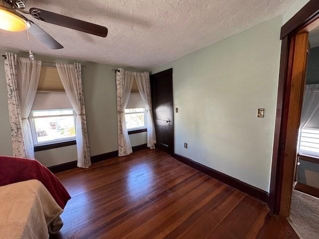 17 Olcott St, Watertown, MA 02472 - bedroom with a textured ceiling, baseboards, and wood finished floors