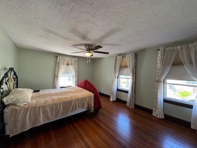 17 Olcott St, Watertown, MA 02472 - bedroom with baseboards, multiple windows, and wood finished floors