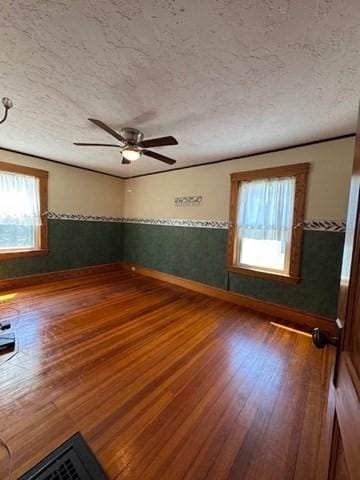 17 Olcott St, Watertown, MA 02472 - unfurnished room with baseboards, a ceiling fan, a textured ceiling, and wood finished floors