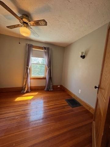 17 Olcott St, Watertown, MA 02472 - unfurnished room featuring visible vents, baseboards, and wood finished floors