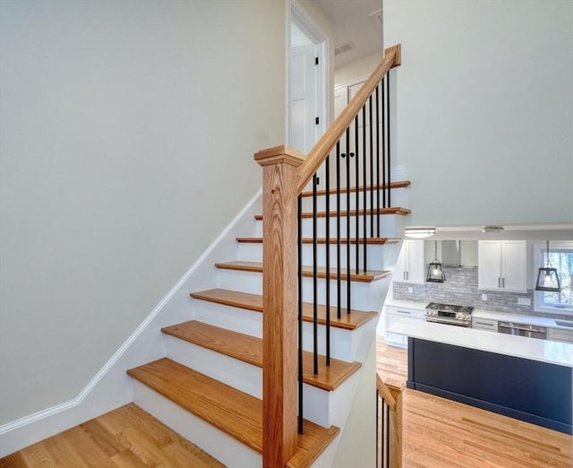 stairs featuring wood finished floors