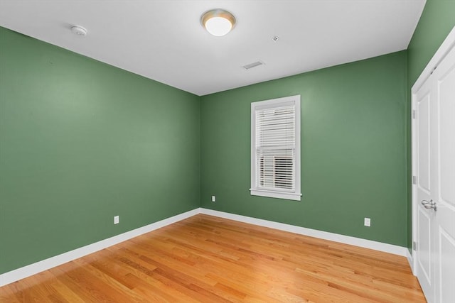 unfurnished room with hardwood / wood-style floors