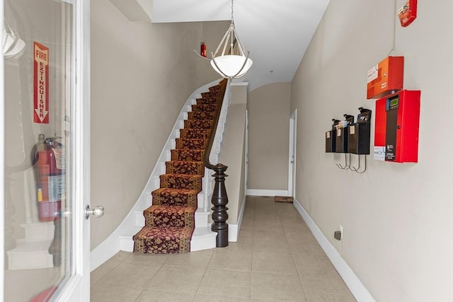 stairway with tile patterned floors