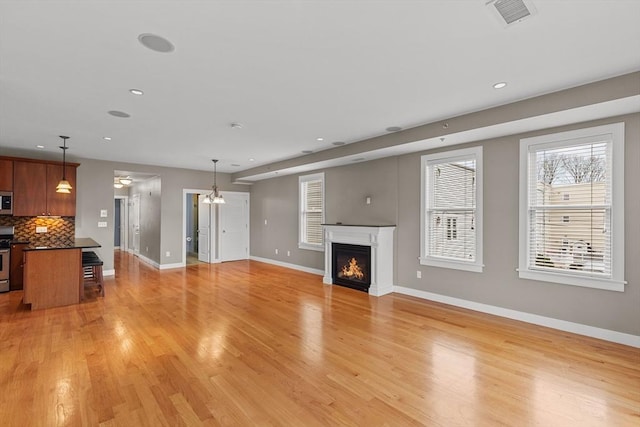 unfurnished living room featuring light hardwood / wood-style floors