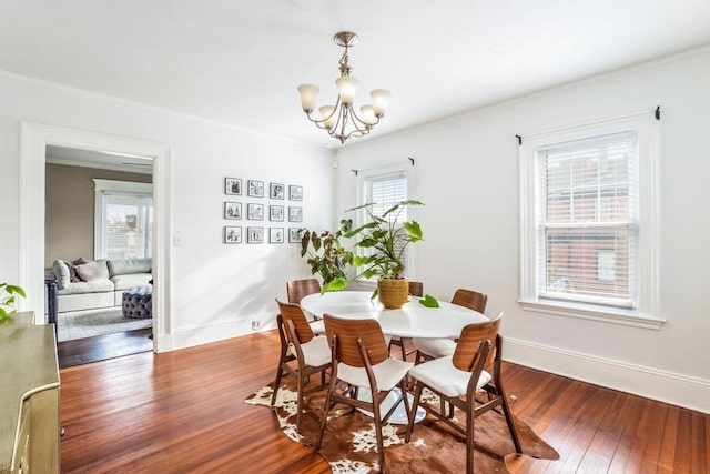 dining space with an inviting chandelier, a healthy amount of sunlight, and hardwood / wood-style floors