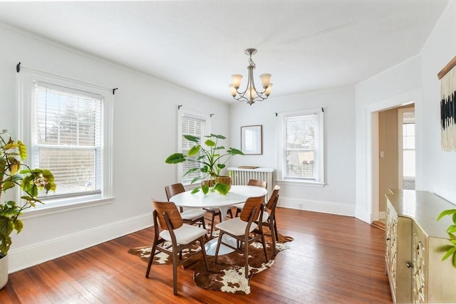 dining space featuring an inviting chandelier and dark hardwood / wood-style flooring