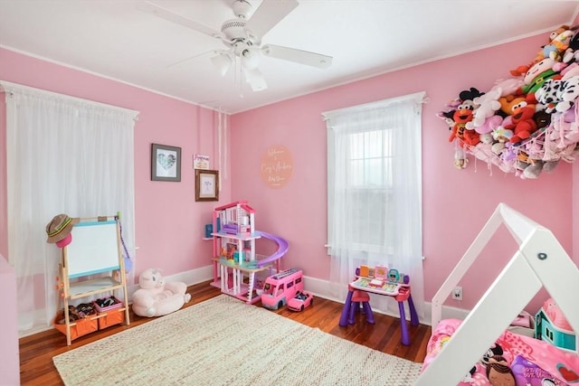 playroom with ceiling fan and hardwood / wood-style floors