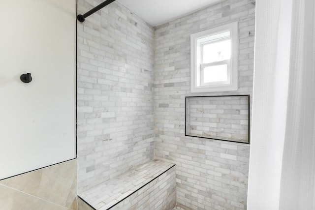 bathroom with a tile shower