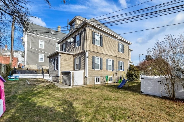 rear view of house featuring a yard