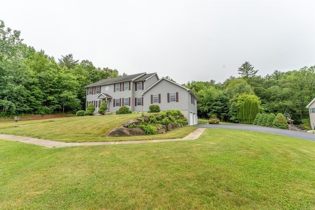 39 Grey Fox Lndg, Woodstock, CT 06281 - colonial-style house featuring asphalt driveway, a front yard, an attached garage, and a wooded view