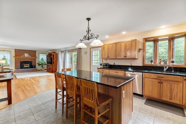 39 Grey Fox Lndg, Woodstock, CT 06281 - kitchen featuring dishwasher, light tile patterned flooring, a center island, a kitchen bar, and hanging light fixtures