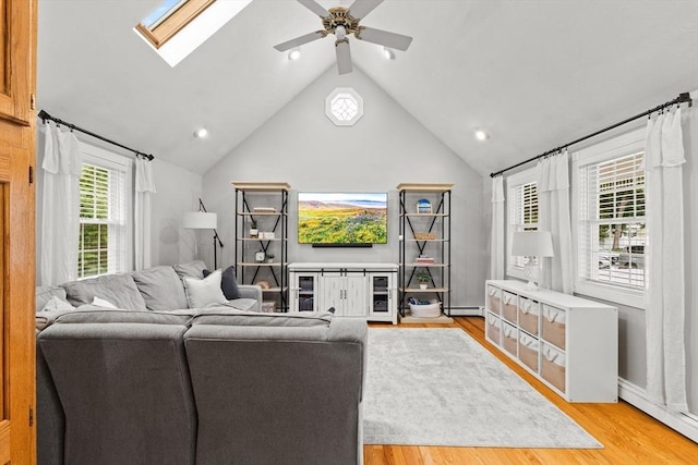 45 S Elm St, West Bridgewater, MA 02379 - living room featuring light wood-type flooring, ceiling fan, a skylight, lofted ceiling, and a baseboard heating unit