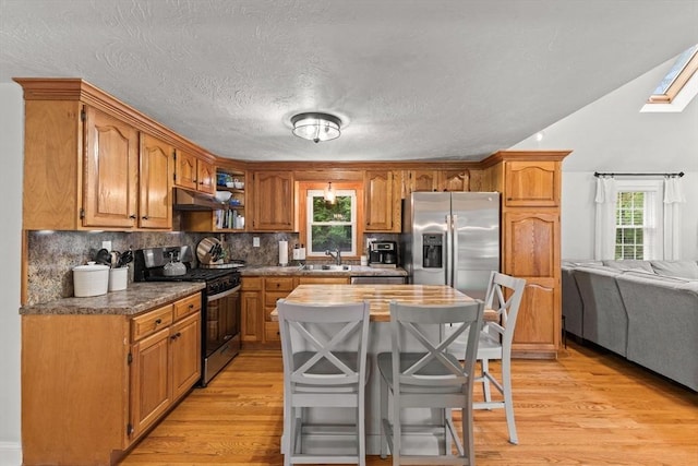 45 S Elm St, West Bridgewater, MA 02379 - kitchen with appliances with stainless steel finishes, light wood-style floors, under cabinet range hood, tasteful backsplash, and a skylight