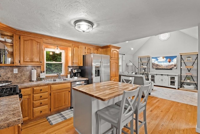 45 S Elm St, West Bridgewater, MA 02379 - kitchen featuring stainless steel appliances, light wood finished floors, wood counters, a breakfast bar, and vaulted ceiling