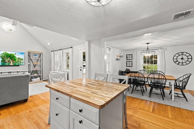 45 S Elm St, West Bridgewater, MA 02379 - kitchen featuring butcher block counters, light wood finished floors, healthy amount of natural light, a textured ceiling, and vaulted ceiling
