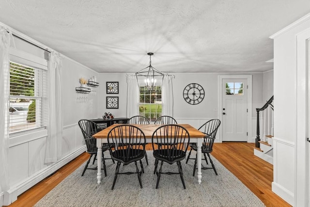 45 S Elm St, West Bridgewater, MA 02379 - dining area featuring a baseboard heating unit, light wood-style floors, a chandelier, ornamental molding, and healthy amount of natural light