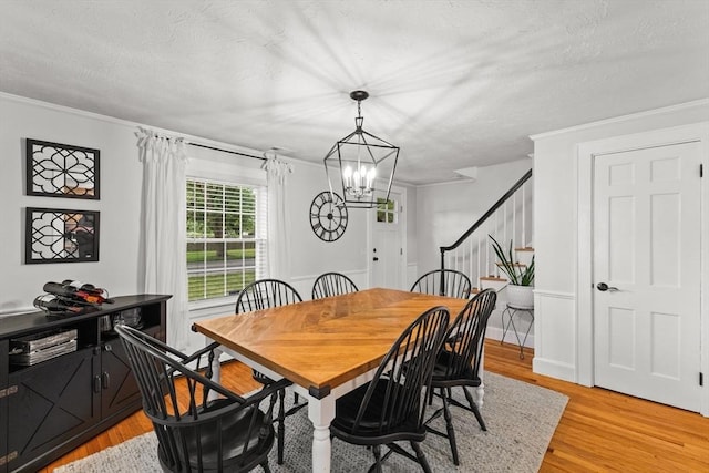 45 S Elm St, West Bridgewater, MA 02379 - dining room featuring a chandelier, light wood-style flooring, stairs, a textured ceiling, and ornamental molding