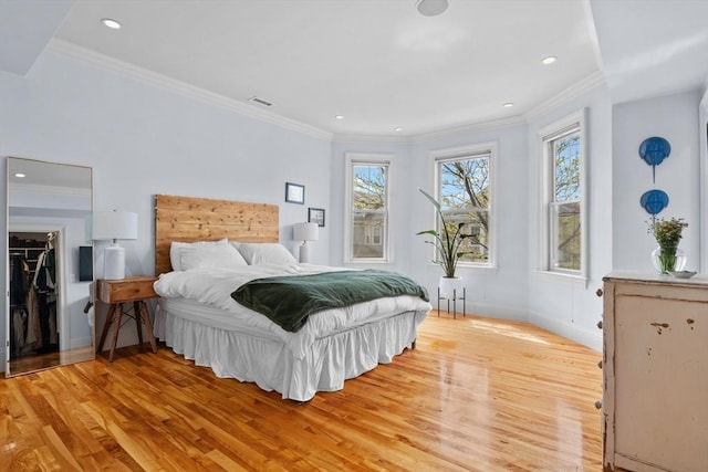 bedroom with recessed lighting, light wood-style flooring, and crown molding
