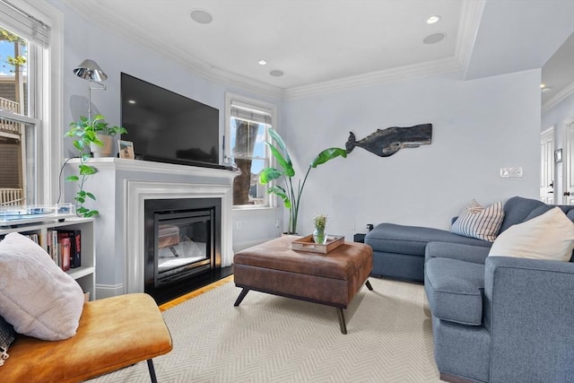 living area with crown molding, a wealth of natural light, a fireplace with flush hearth, and recessed lighting